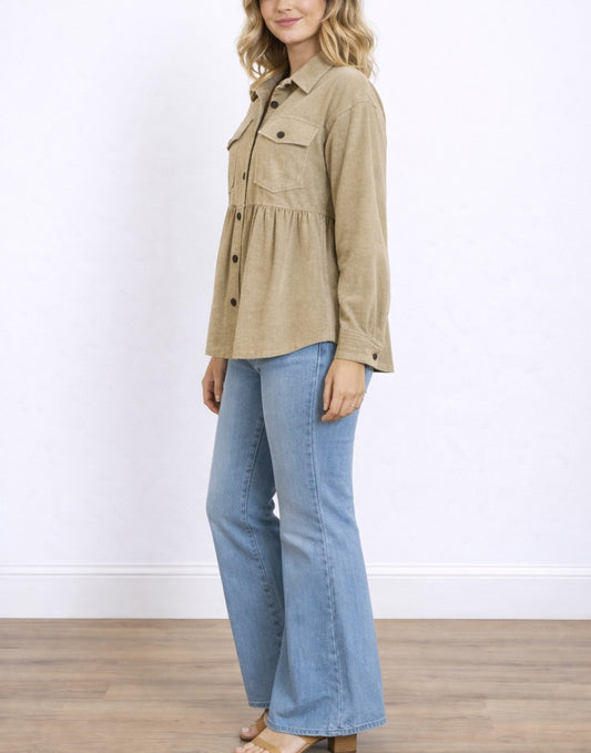 Side view of woman wearing a beige Flap Pocket Drop Shoulder Peplum Shirt and blue jeans on a white background.
