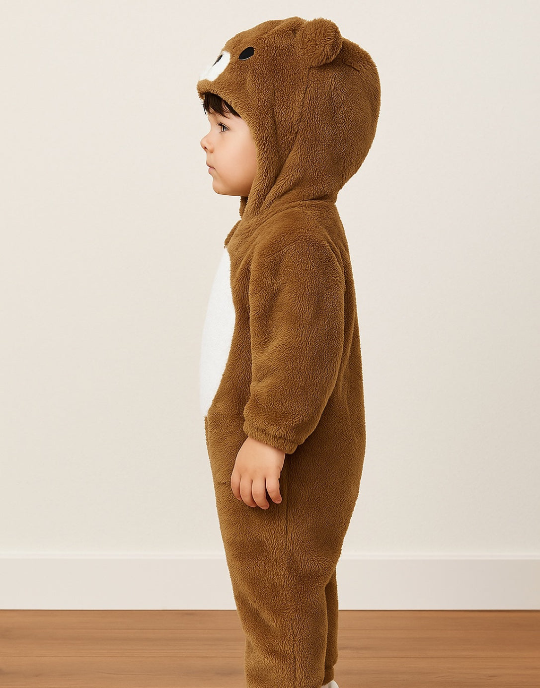 Side view of child wearing a brown Boys 3D Ear Hooded Jumpsuit against a plain background