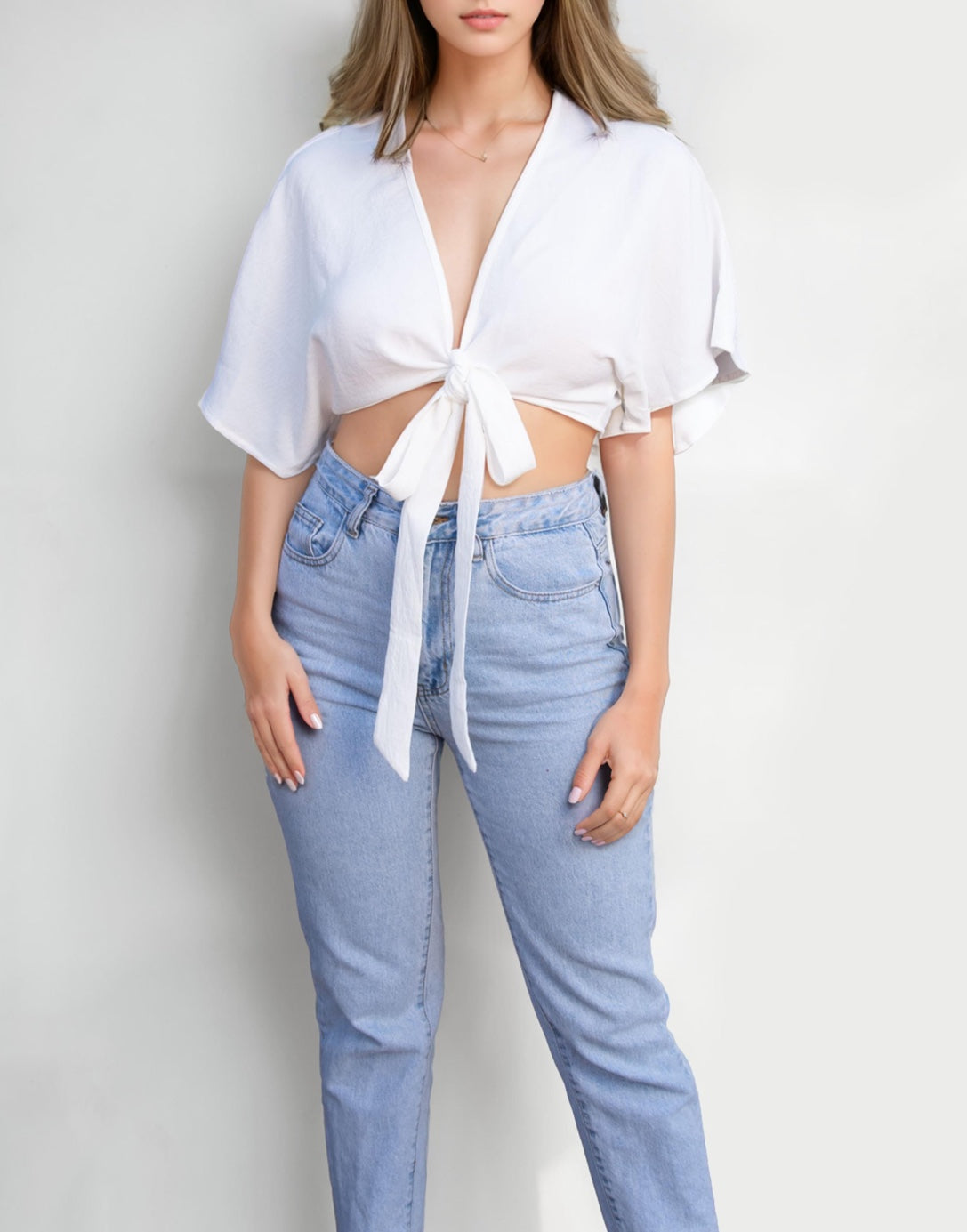 Full length photo of Kimono Sleeve Crop Top with light wash denim jeans.
