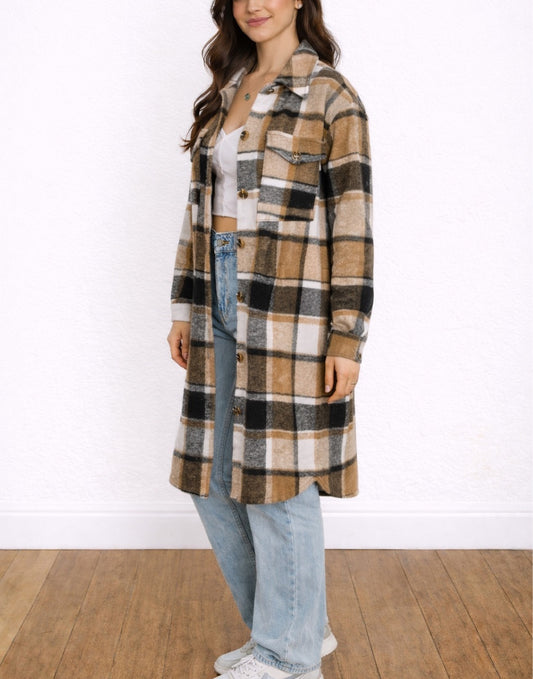 Side view of Woman wearing a plaid Long Shirt Jacket over a white crop top and jeans on a white background.