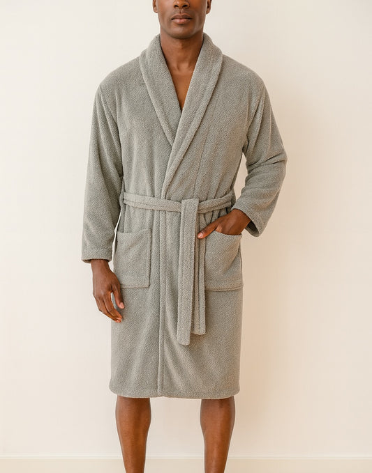 Man wearing a gray Bathrobe against a plain background