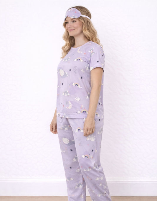Side view of woman wearing a purple Pajama Set and Eye Cover with cloud and moon patterns on a white background.