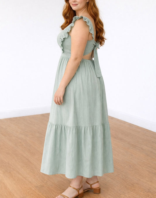 Side view of woman wearing a green Plus Size Square Neck Maxi Dress with ruffled straps on a plain background.