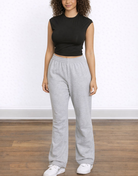 Woman wearing a black Crop Knit Tee and white skirt against a yellow and white background
