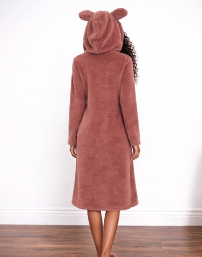 Back view of woman wearing a pink hooded Nightdress with bear ears on a white background.