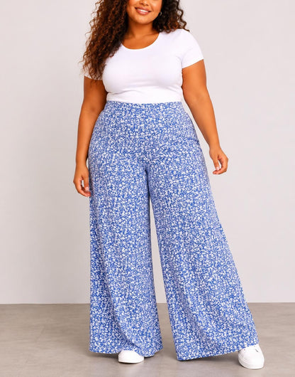 Woman wearing blue floral Plus Size High Waist Wide Leg Pants and a white top against a plain background