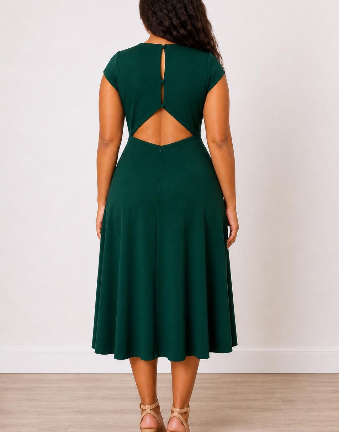 Back view of woman wearing a green Plus Size Open Back Cap Sleeve Midi Dress on a white background.
