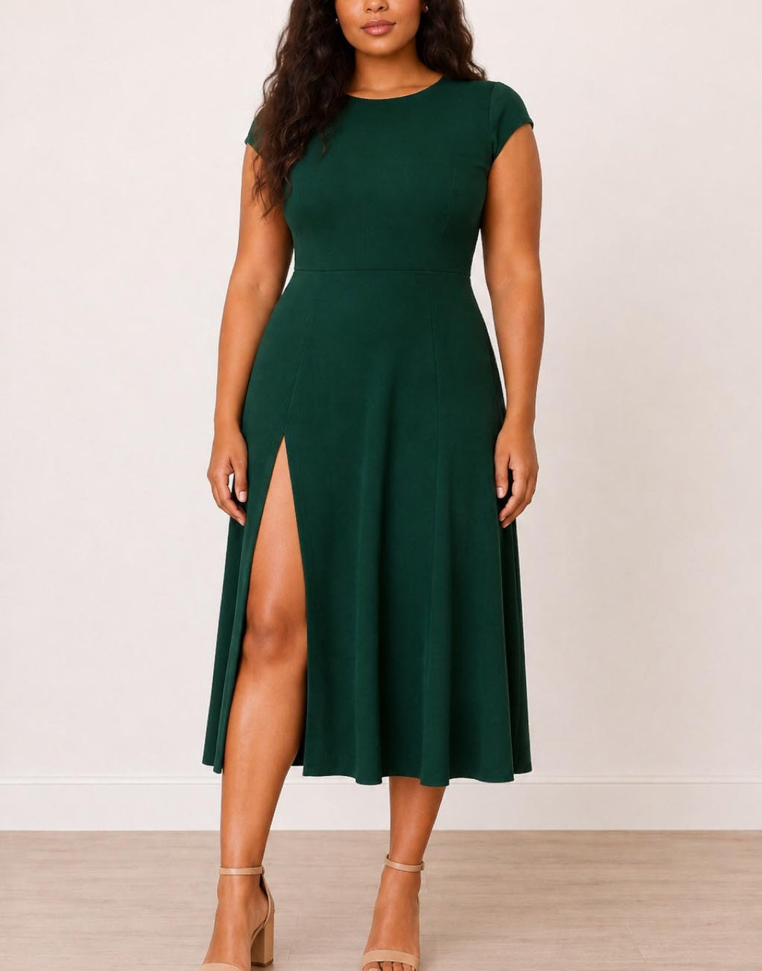Woman wearing a green Plus Size Cap Sleeve Midi Dress with a slit on a white background.