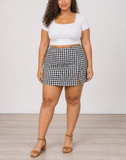 Woman wearing black and white gingham Plus Size Split Hem Skort with white top.