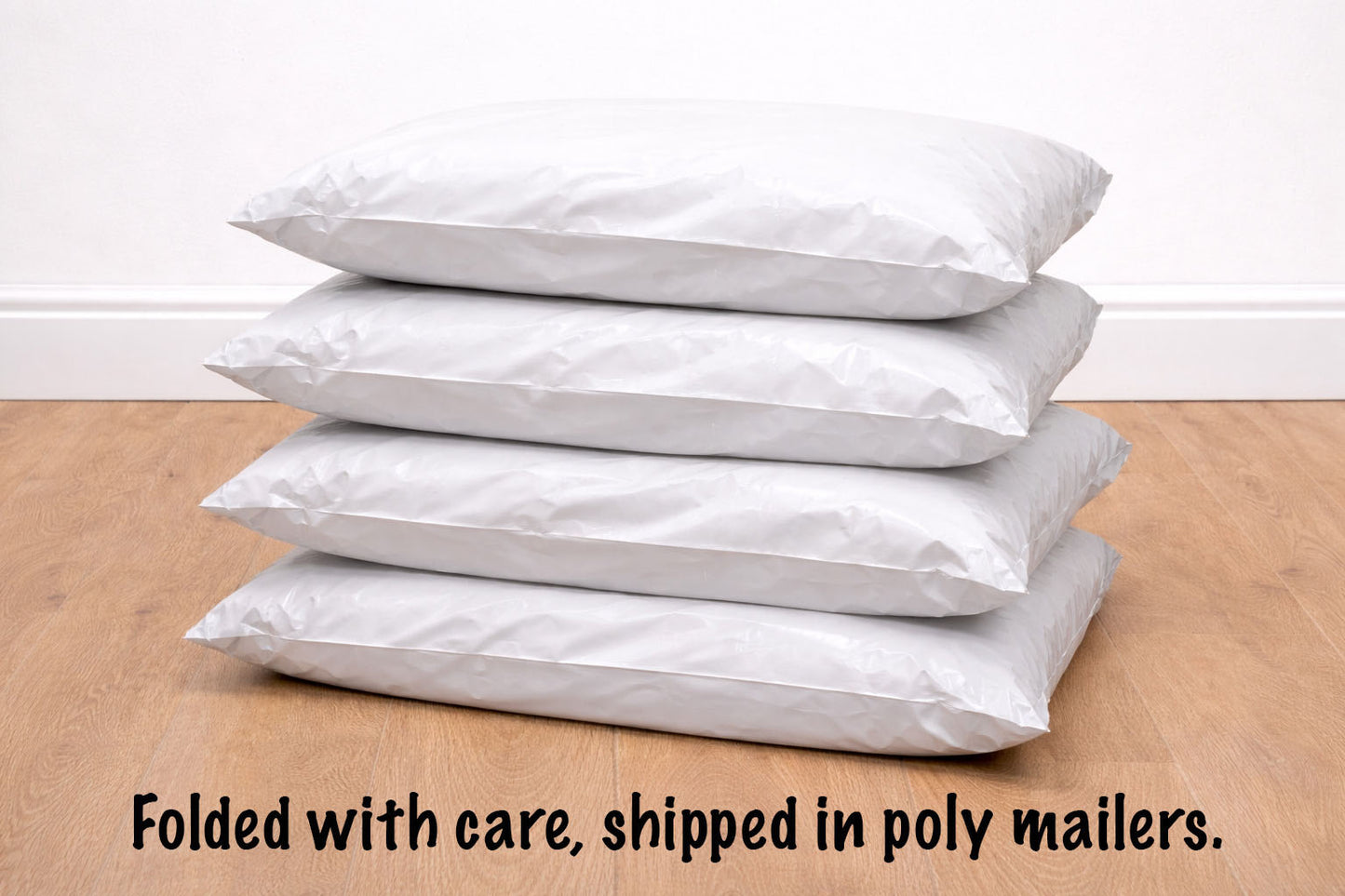 Stack of white poly mailers on a wooden surface with text indicating care and shipping information.