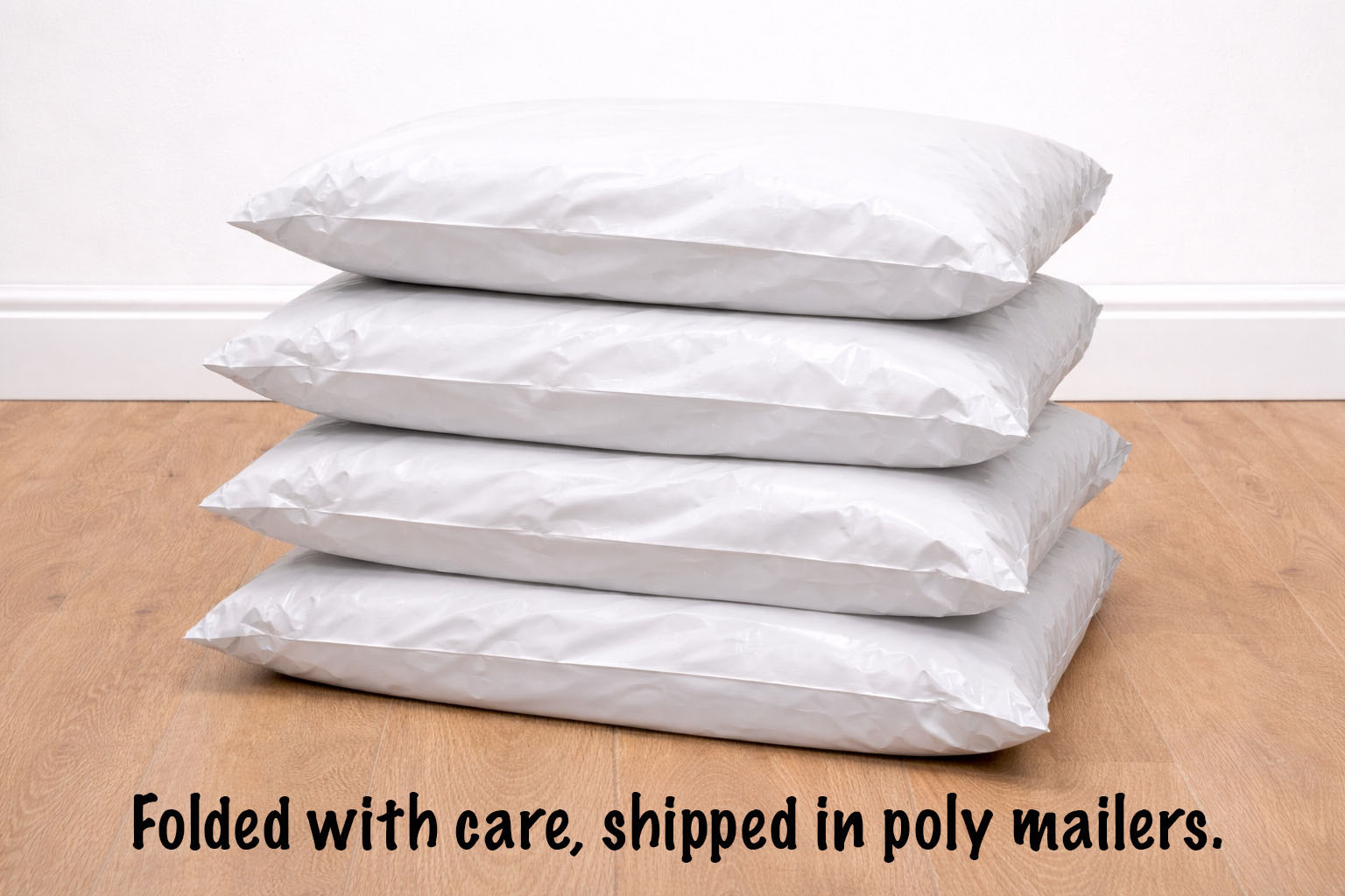 Stack of white poly mailers on a wooden surface with text indicating care and shipping information.