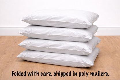 Stack of white poly mailers on a wooden surface with text indicating care and shipping information.
