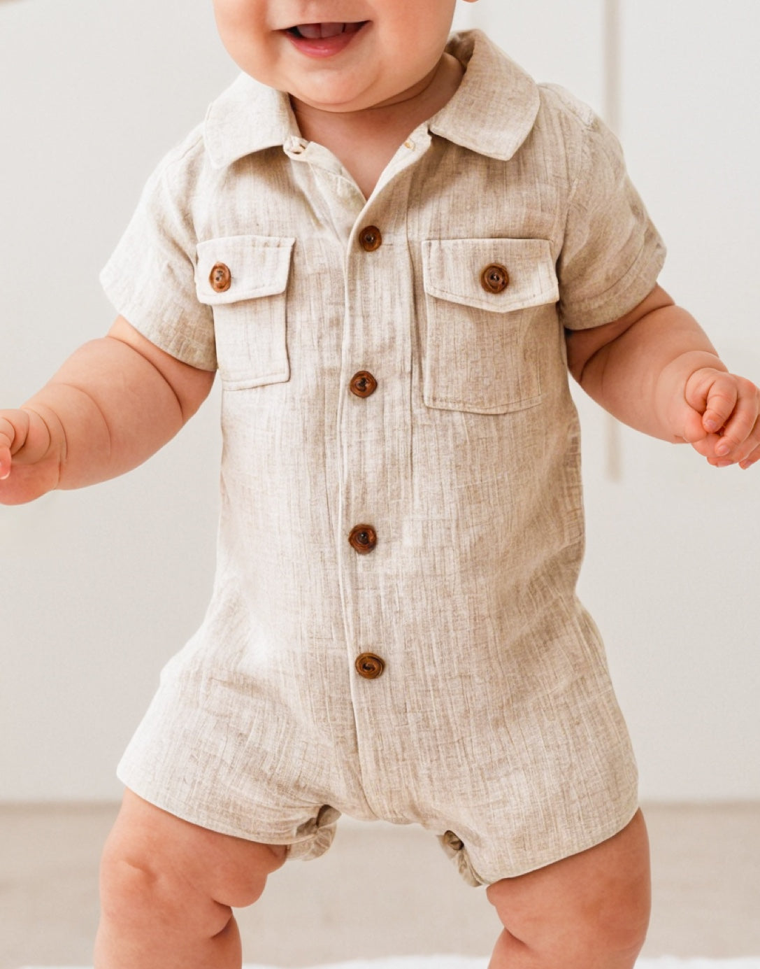 Side view of Baby Boy Flap Pocket Shirt Romper.