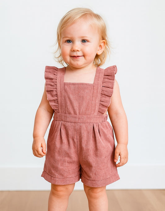 Child wearing a pink Baby Ruffle Sleeve Square Neck Romper against a plain background