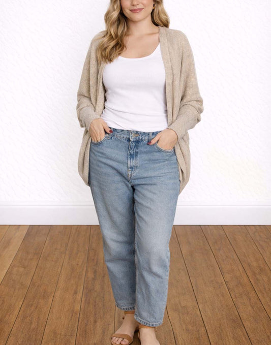 Woman wearing a beige Batwing Sleeve Cardigan, white tank top, and blue jeans on a wooden floor.