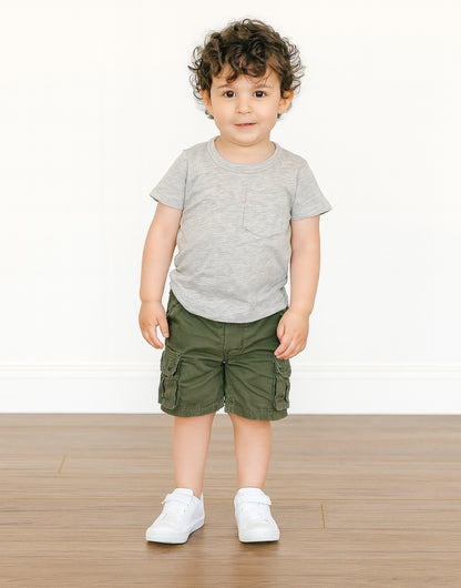 Child wearing a gray Pocket Patched Tee and green cargo shorts on a white background