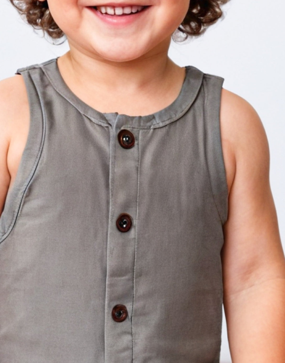 Neckline closeup of Boys Sleeveless Button Down Romper.
