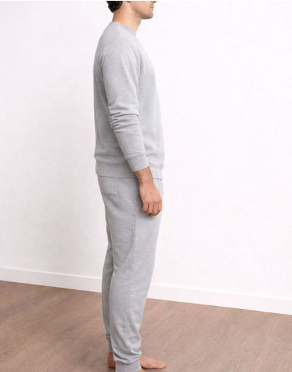 Side view of person wearing a gray sweatshirt and Drawstring Jogger Pants against a white wall.