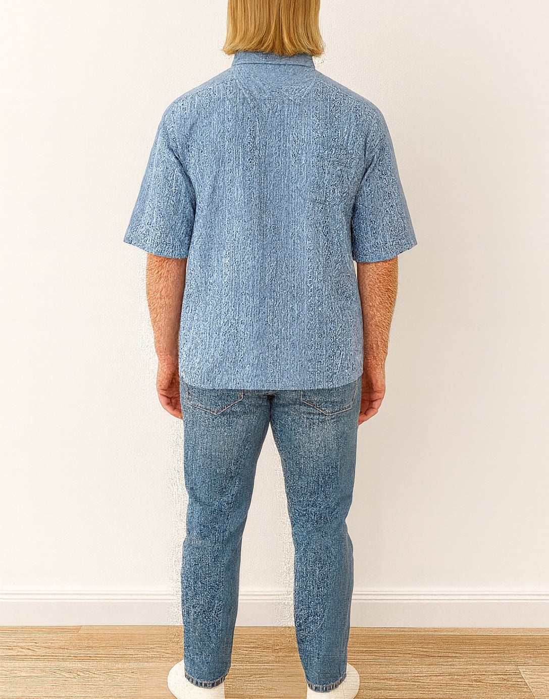Back view of person wearing a blue patterned Drop Shoulder Loose Fit Shirt and denim jeans against a plain background