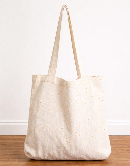 Beige Tote Bag with subtle pattern on a wooden surface