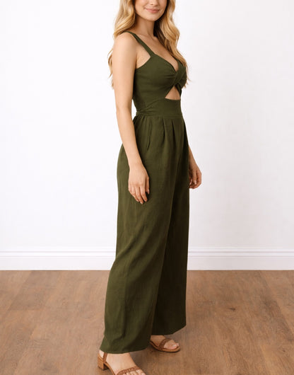 Side view of woman wearing a green Front Twist Shoulder Strap Overall Jumpsuit with a cutout design on a white background.