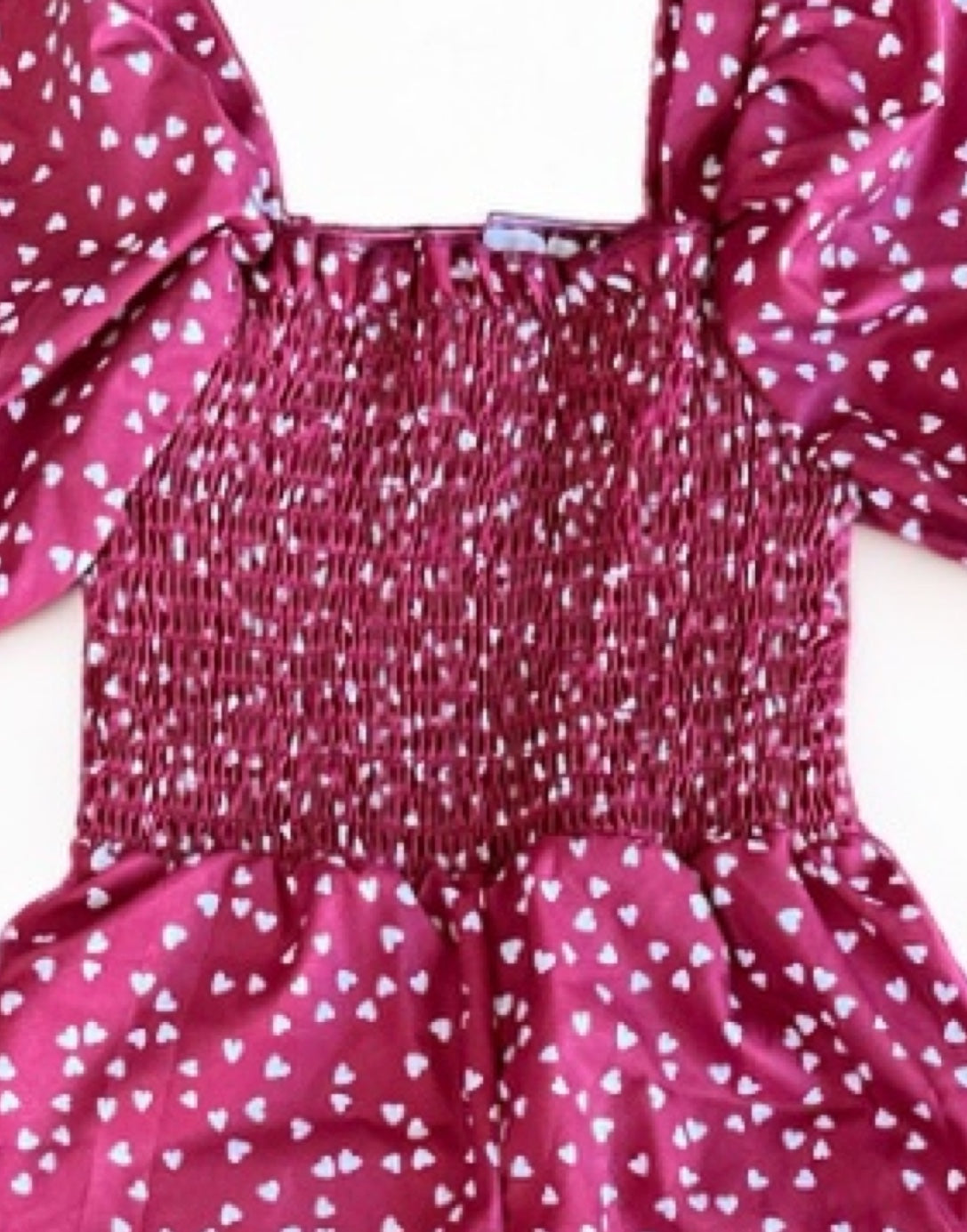 Neckline closeup of Girls Puff Sleeve Shirred Jumpsuit.