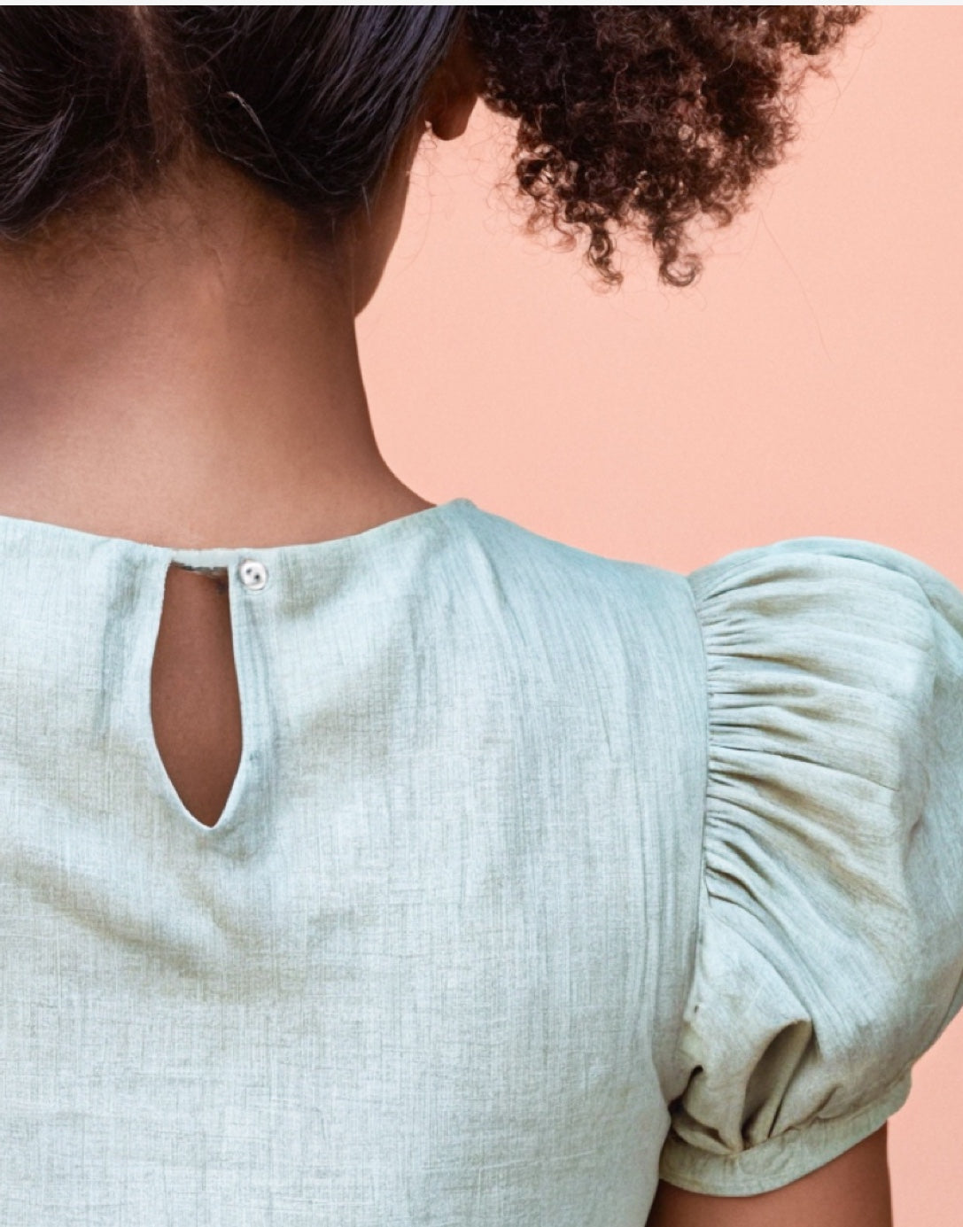 Keyhole closeup of Ruffle Trim Puff Sleeve Blouse.