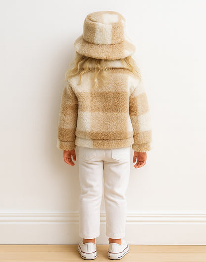 Back view of child wearing a beige and white striped Teddy Jacket with a matching hat against a white wall.