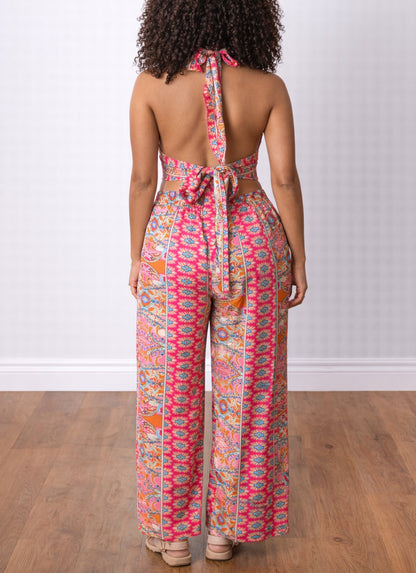 Back view of woman wearing a colorful patterned Halter Crop Top and Wide Leg Pants Set on a wooden floor.