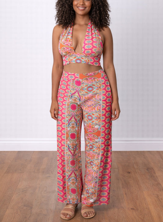 Woman wearing a colorful patterned Halter Crop Top and Wide Leg Pants Set on a wooden floor.