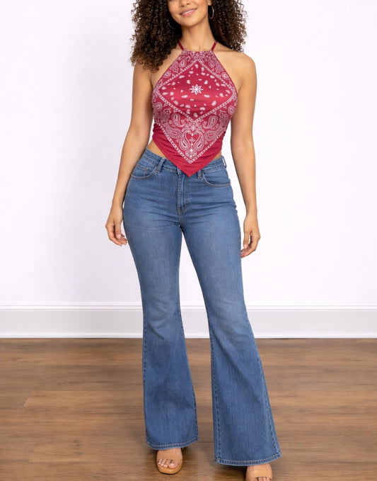 Woman wearing a red bandana Handkerchief Halter Top and blue jeans on a white background.