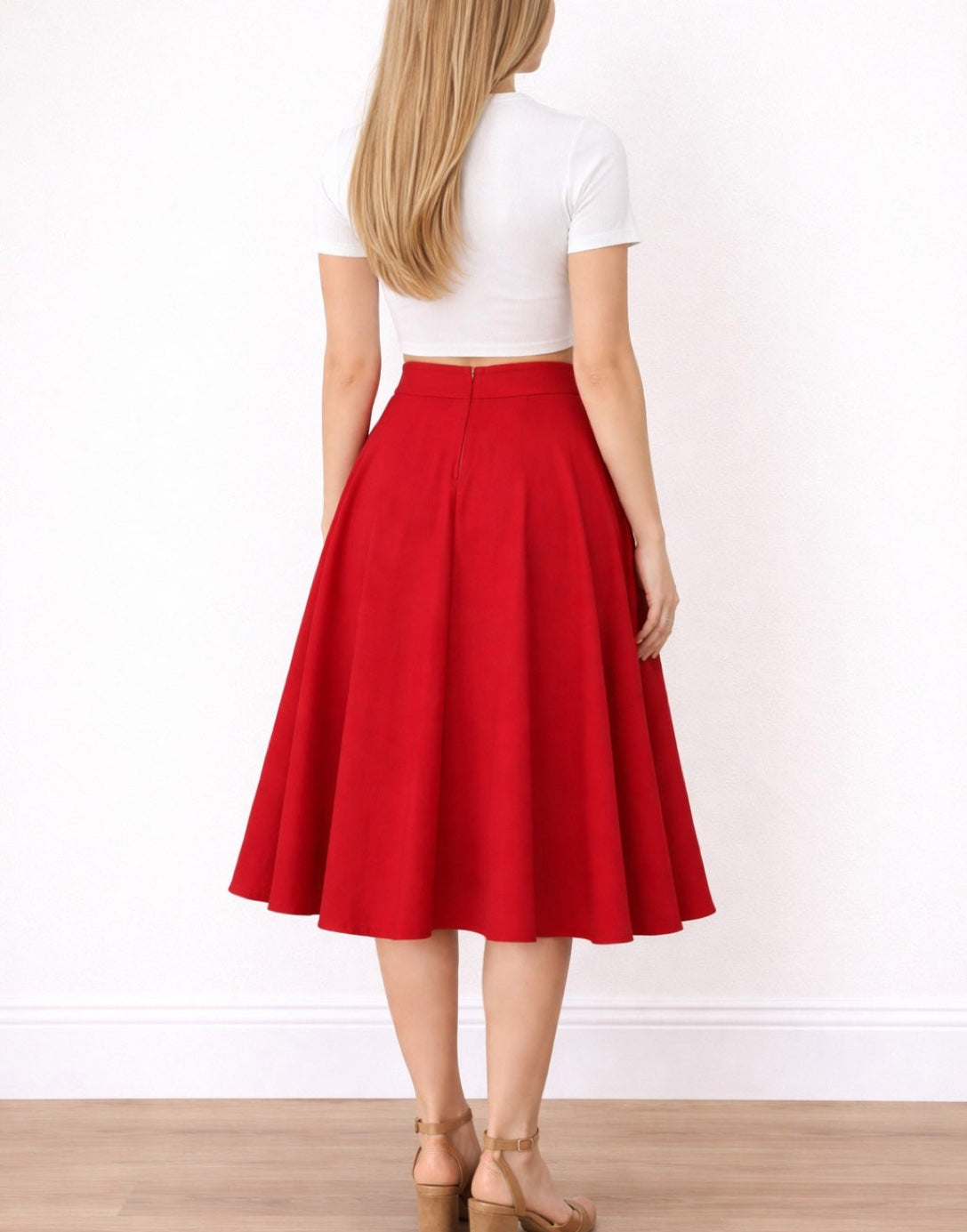 Back view of woman wearing a white top and red High Waist Midi Circle Skirt on a white background.