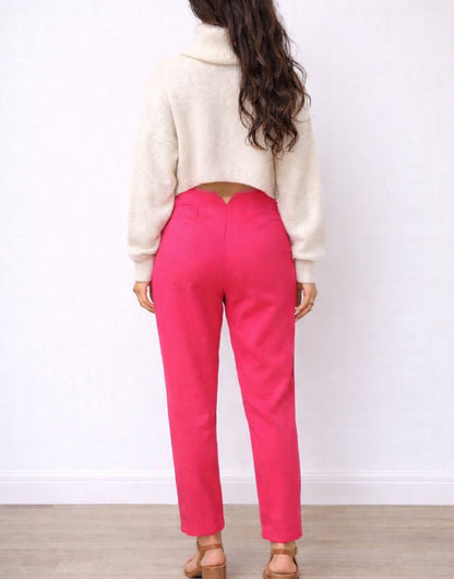 Back view of woman wearing a white sweater and bright pink High Waist Straight Leg Pants on a plain background.