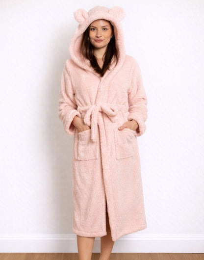 Woman wearing a pink Hooded Bathrobe with bear ears on a white background
