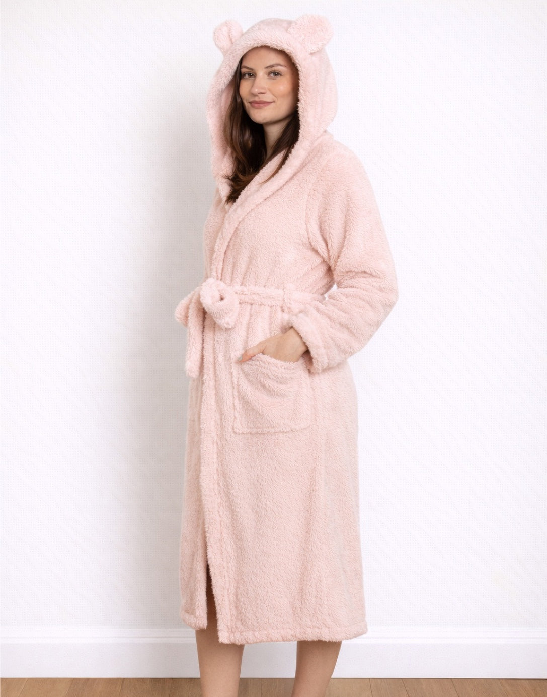 Side view of woman wearing a pink Hooded Bathrobe with bear ears on a white background
