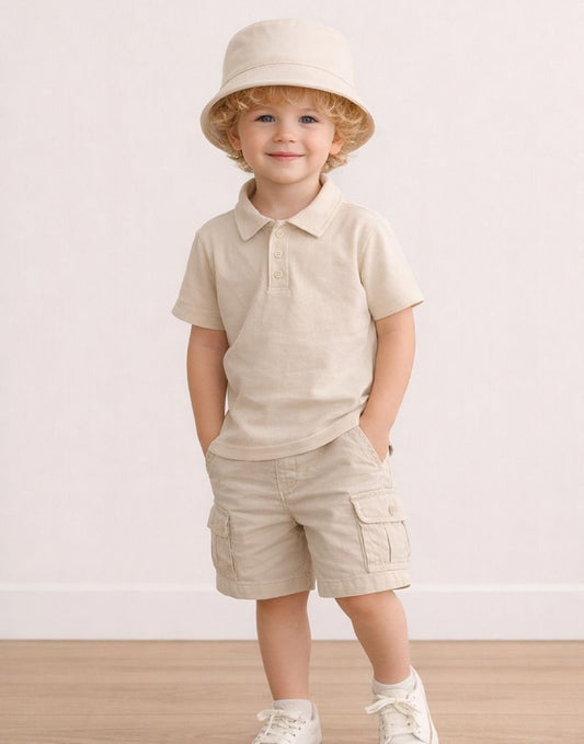 Child wearing a beige outfit with a Bucket Hat on a plain background