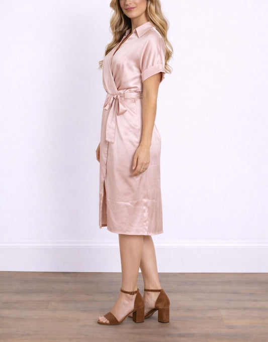 Side view of woman wearing a pink satin Kimono Shirt Wrap Dress against a white background.