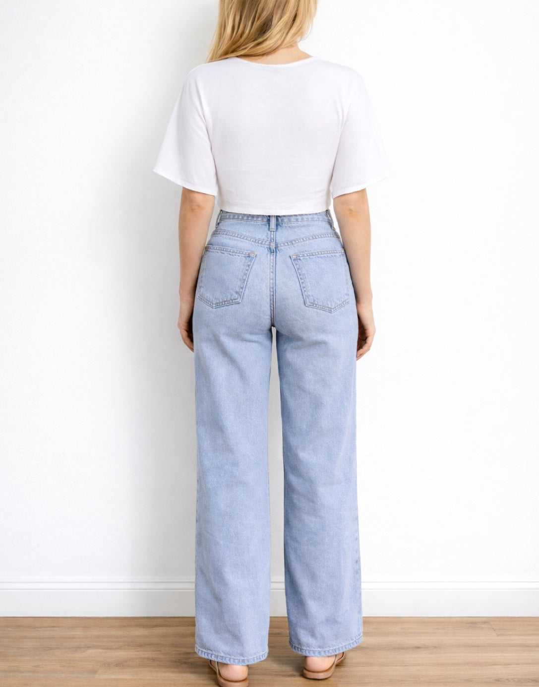 Back view of woman wearing a white Kimono Sleeve Crop Top and light blue jeans against a plain background.