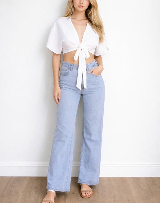 Woman wearing a white Kimono Sleeve Crop Top and light blue jeans against a plain background.