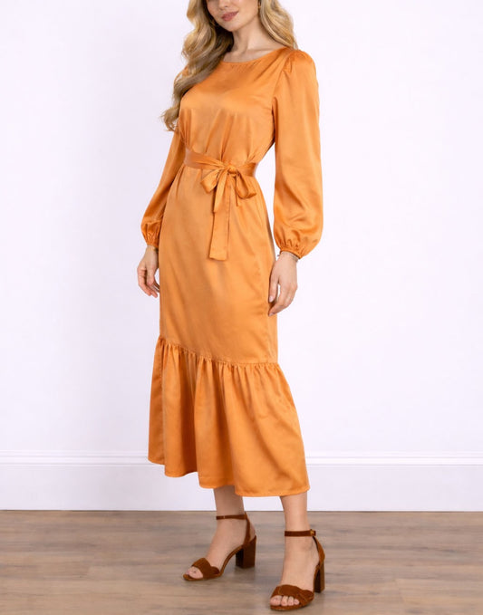 Side view of woman wearing an orange Lantern Sleeve Belted Maxi Dress with a white background.