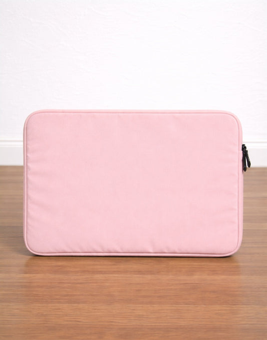Pink Laptop Bag on a wooden surface with a white background
