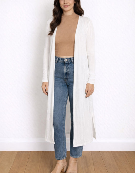 Woman wearing a white Long Cardigan, beige top, and blue jeans on a white background