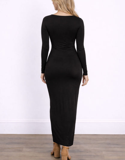 Back view of woman wearing a black long-sleeve Maxi Bodycon Dress against a white wall.