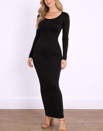 Woman wearing a black long-sleeve Maxi Bodycon Dress against a white wall.