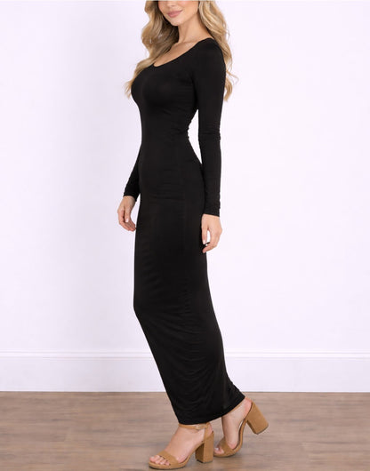 Side view of woman wearing a black long-sleeve Maxi Bodycon Dress against a white wall.