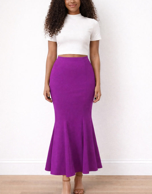 Woman wearing a white top and purple Mermaid Skirt on a plain background