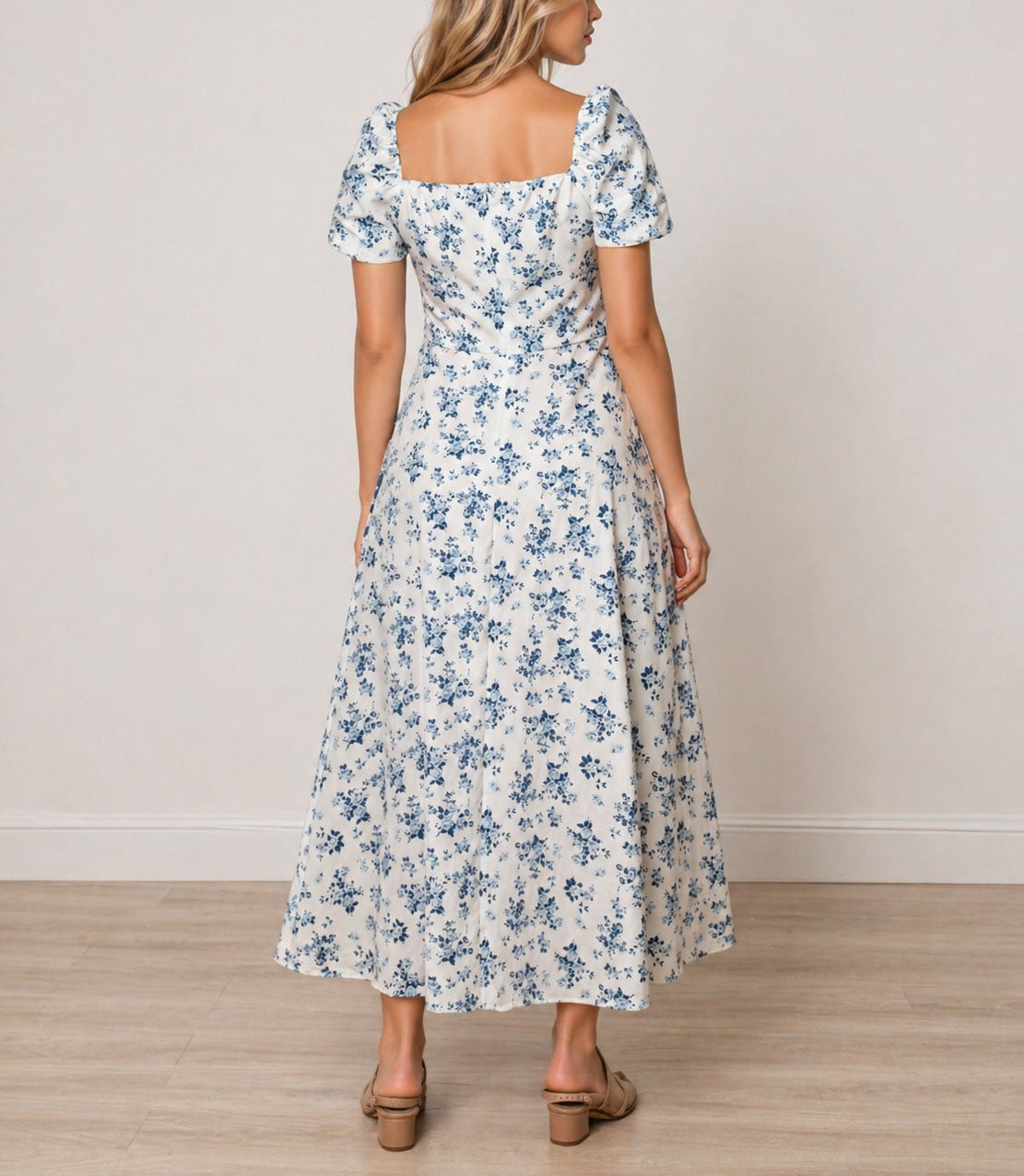 Back view of woman wearing a floral Milkmaid Front Tie Maxi Dress on a plain background.