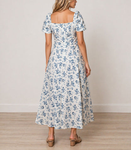 Back view of woman wearing a floral Milkmaid Front Tie Maxi Dress on a plain background.