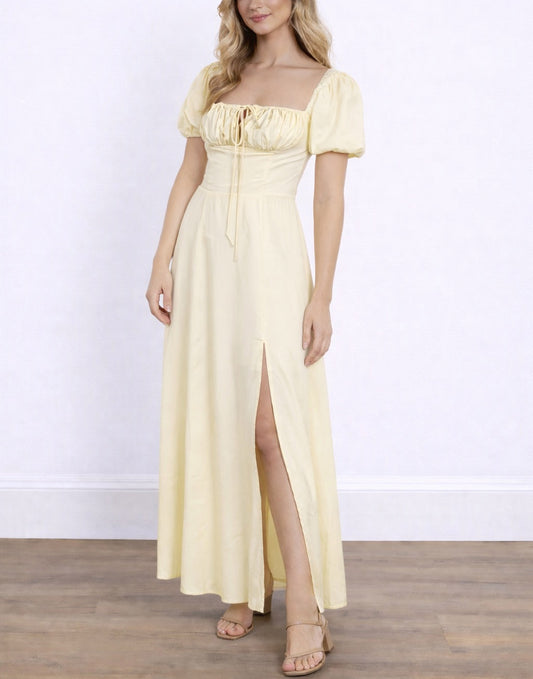 Woman wearing a light yellow Off Shoulder Milkmaid Maxi Dress with a slit on a white background
