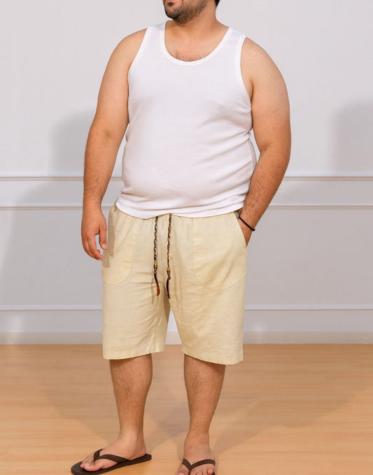 Person wearing white tank top and cream color Plus Size Drawstring Knee Length Shorts with plain background and wood flooring.
